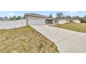 Long concrete driveway leading to a two-car garage at 4335 Sw 159Th Ave, Ocala, FL 34481