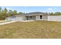 New construction home with a gray exterior and white fence at 4335 Sw 159Th Ave, Ocala, FL 34481