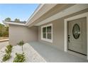 Modern front door with sidelights and charming landscaping at 4335 Sw 159Th Ave, Ocala, FL 34481