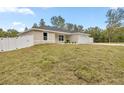 New construction home with a white vinyl fence and grassy yard at 4353 Sw 159Th Ave, Ocala, FL 34481