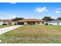 Tan house with brown roof, screened porch, and spacious yard at 4535 Nw 34Th Pl, Ocala, FL 34482