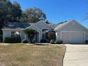 Single-story house with attached garage and manicured lawn at 8027 Sw 116Th Loop, Ocala, FL 34481