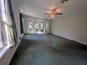 Large bedroom with plush carpet and sliding glass doors at 9100 Se 180Th Avenue Rd, Ocklawaha, FL 32179