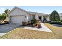 Charming single-story home with a well-manicured lawn, mature landscaping, and a two-car garage at 9836 Sw 75Th Street Rd, Ocala, FL 34481