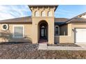 Front entrance with arched entryway, glass door, and brick walkway at 10384 Sw 41St Ave, Ocala, FL 34476