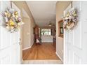 Bright entryway with hardwood floors and view into the living room at 11642 Sw 71St Cir, Ocala, FL 34476