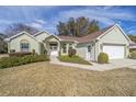 House exterior showcasing landscaping and a two-car garage at 11642 Sw 71St Cir, Ocala, FL 34476