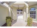 Front entrance with double doors, wreaths, and a covered porch at 11642 Sw 71St Cir, Ocala, FL 34476