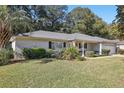 One story home with a grey exterior and lush landscaping at 14146 Sw 112Th Cir, Dunnellon, FL 34432