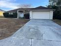 House exterior with a brick driveway and landscaping at 16025 Sw 25Th Ter, Ocala, FL 34473