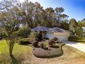 Single-story house with landscaped yard and paved driveway at 19247 Sw 98Th Loop, Dunnellon, FL 34432