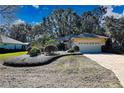 Single story house with mature trees and landscaped yard at 19247 Sw 98Th Loop, Dunnellon, FL 34432