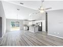 Open living space with high ceilings, LVP flooring, and a ceiling fan at 201 Locust Rd, Ocala, FL 34472