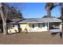 Ranch style home with palm tree and mature landscaping at 21465 Sw Honeysuckle St, Dunnellon, FL 34431