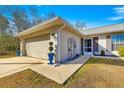 The home's exterior showcases a neutral color palette, landscaping, and a large garage at 24 Pine Course Pl, Ocala, FL 34472