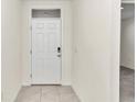 Interior entryway with white door and neutral walls at 27 Hickory Course Ln, Ocala, FL 34472