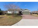 Charming two-story home featuring a well-manicured lawn, stone accents, and neutral toned exterior at 3690 Nw 56Th Ave, Ocala, FL 34482