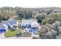 An aerial view showcasing a single-story house with a neatly landscaped front yard at 3923 Manor Oaks Ct, Leesburg, FL 34748