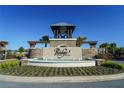 Elegant entrance to the Ridge at Heath Brook community featuring a stone arch and fountain at 5429 Sw 44Th Court Rd, Ocala, FL 34474