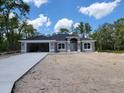 Charming single-story home with a modern design, two-car garage, and inviting front entrance at 6915 Sw 152Nd St, Ocala, FL 34473