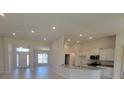 Open kitchen with granite countertops and stainless steel appliances at 6915 Sw 152Nd St, Ocala, FL 34473