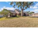 Brown house with a large tree in front at 700 Se 49Th Ave, Ocala, FL 34471