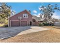 Three-car garage with a basketball hoop at 700 Se 49Th Ave, Ocala, FL 34471