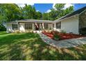 Updated home exterior showcasing a red mulch bed at 8930 Sw 8Th St, Ocala, FL 34481