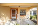 Front porch with two rocking chairs and a small side table at 9111 Sw 102Nd Cir, Ocala, FL 34481