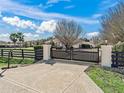 Long driveway leading to a home with a gated entrance at 9270 Sw 9Th Ter, Ocala, FL 34476