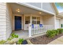 Inviting front porch with blue door and white railing at 9662 Sw 95Th Ct # A, Ocala, FL 34481