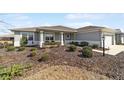 Single-story house with covered porch and landscaping at 10445 Sw 89Th Pl, Ocala, FL 34481