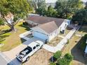 House with a large backyard and a truck parked in the driveway at 10602 Se 179Th Ln, Summerfield, FL 34491