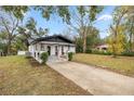 House exterior showcasing landscaping and driveway at 11 Bahia Court Loop, Ocala, FL 34472