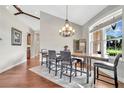 Elegant dining room featuring a live-edge wood table, chandelier, and hardwood floors at 12000 S Highway 475, Ocala, FL 34480