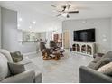 Spacious living room with tile floors, neutral paint, ceiling fan, and comfortable seating area at 205 Brevard Ave, Lady Lake, FL 32159