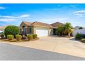 Single-story house with a two-car garage and landscaped yard at 2997 Teasdale Ter, The Villages, FL 32163