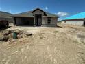 Single Gathering house under construction featuring an open garage, neutral colors, and craftsman-style design under a blue sky at 3168 Ne 46Th Ave, Ocala, FL 34470