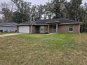 Front view of a one-story house with a grassy yard at 3752 Se 130Th St, Belleview, FL 34420