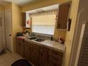 Kitchen with wood cabinets and double sink at 3915 Sw 139Th Street Rd, Ocala, FL 34473