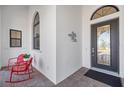 Front porch with two red rocking chairs and a black front door at 5141 Greens Dr, Lady Lake, FL 32159