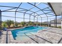 Screened pool and patio area with a spacious backyard at 5141 Greens Dr, Lady Lake, FL 32159
