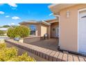 Covered patio with seating area, brick wall, and lush greenery at 8125 Sw 81St Loop, Ocala, FL 34476