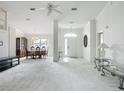 Spacious open-concept living room and dining area with elegant chandelier and neutral color palette at 8574 Sw 60Th Ct, Ocala, FL 34476