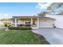 Charming single-story home with well-manicured lawn, cozy front porch, and attached two-car garage at 8648 Sw 95Th Ln # A, Ocala, FL 34481