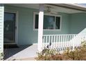 Covered porch with white railing, ceiling fan, and light blue walls at 8667 Sw 108Th Pl, Ocala, FL 34481