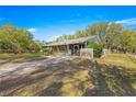 Light green house with a large yard and trees at 10425 Se 159Th Lane, Summerfield, FL 34491