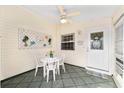 Cozy screened porch with tile flooring, a ceiling fan, and a charming welcome mat at 1112 Carvello Dr, The Villages, FL 32162