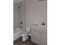 Modern bathroom featuring gray vanity, white toilet, and marble-style shower at 14259 Se 33Rd Ter, Summerfield, FL 34491