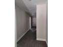 Clean hallway with gray walls and dark gray flooring at 14259 Se 33Rd Ter, Summerfield, FL 34491